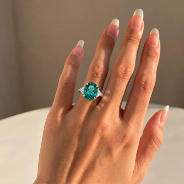 7.6ct Oval Lab Grown Emerald Ring With Trillion Diamond Side Stones