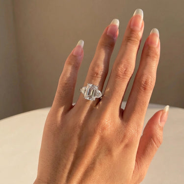 Emerald Cut Three Stone Diamond Engagement Ring With Heart Side Stones