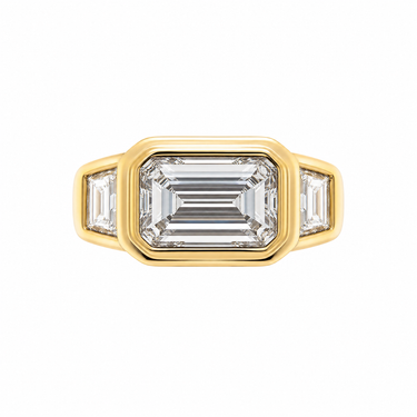 East West Emerald Cut Diamond Bezel Ring With Trapezoid Side Stones